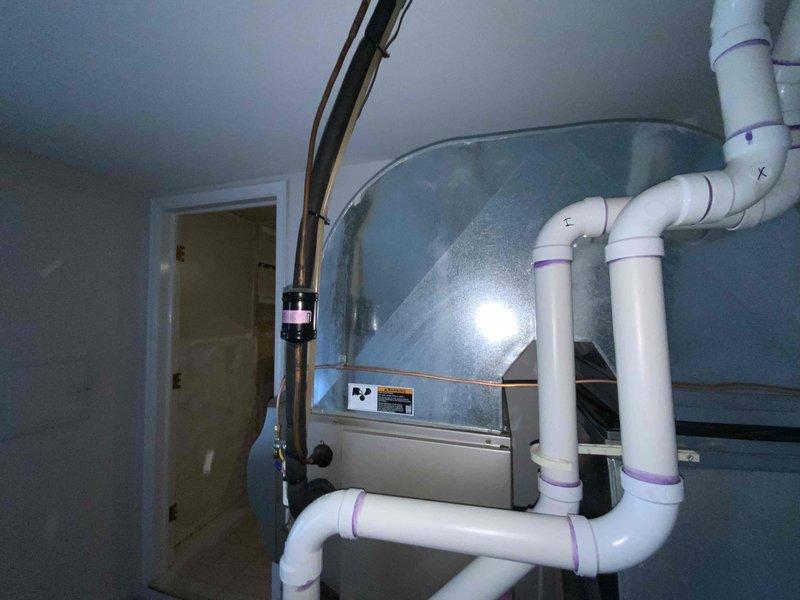 Completed estimate for air conditioning system replacement on 16-year-old unit. Customer recently had furnace installed and is now seeking replacement of aging AC component. Assessed existing HVAC installation including air handler, ductwork configuration, and condensate drainage system with PVC piping. Provided replacement options and recommendations for new air conditioning system to integrate with recently installed furnace.