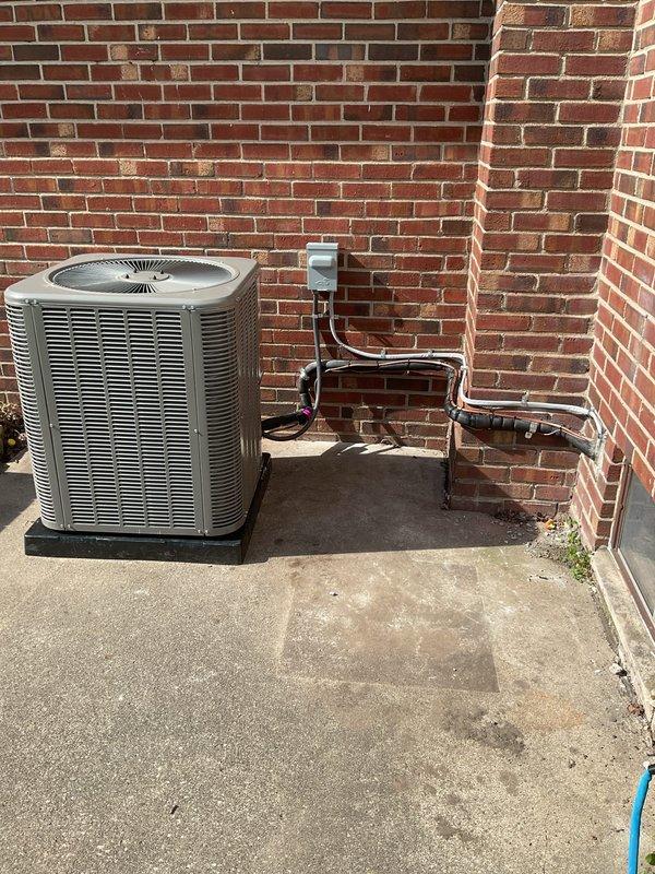 Completed full HVAC system replacement including installation of 90,000 BTU furnace and 3-ton air conditioning unit with rear discharge configuration. Installed furnace in basement utility area with new PVC condensate drain lines, flexible metal supply ductwork, and copper refrigerant line set connected to existing ductwork system. Mounted outdoor condenser unit on concrete pad against exterior brick wall with proper refrigerant line routing, electrical disconnect box, and line set brackets for secure copper tubing installation. Reconnected all electrical and mechanical connections, verified proper system operation, and ensured installation met mechanical permit requirements.