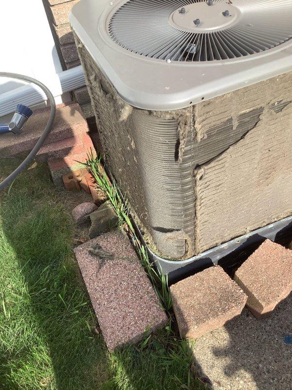 Completed annual cooling maintenance on residential split system air conditioning unit. Upon arrival, observed heavy accumulation of dirt, dust, and grime on condenser exterior panels and coils. Performed comprehensive inspection of outdoor condenser unit including fan motor operation, refrigerant line connections, and electrical components. Cleaned condenser coils and exterior surfaces, removing significant debris buildup that was restricting airflow and reducing system efficiency. Verified proper fan operation and checked refrigerant line insulation integrity. System operational and running within normal parameters upon completion of maintenance service.