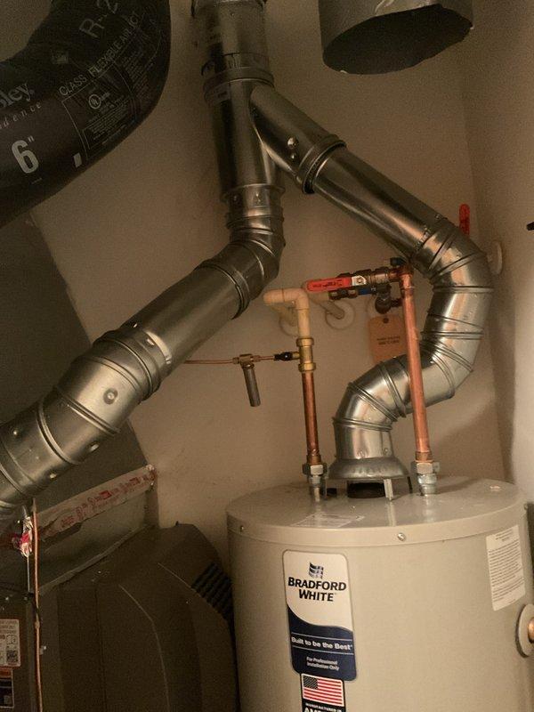 Completed full HVAC system installation including a 70,000 BTU gas furnace, 2-ton air conditioning unit with front-discharge configuration, humidifier, and Bradford White water heater. Installed all necessary ductwork, refrigerant lines, electrical disconnects, and plumbing connections with copper piping and shut-off valves. All mechanical, plumbing, and electrical work completed per permit requirements, with equipment positioned exterior condenser on ground-level pad and interior components in utility closet.