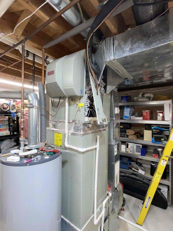 Completed estimate for replacement of 14-year-old non-functioning air conditioning system located in basement mechanical room. Assessed existing HVAC configuration including natural gas furnace, ductwork distribution, and current A/C unit to provide comprehensive replacement proposal. Documented equipment location, utility connections, and structural conditions to develop accurate replacement specifications for new cooling system installation.