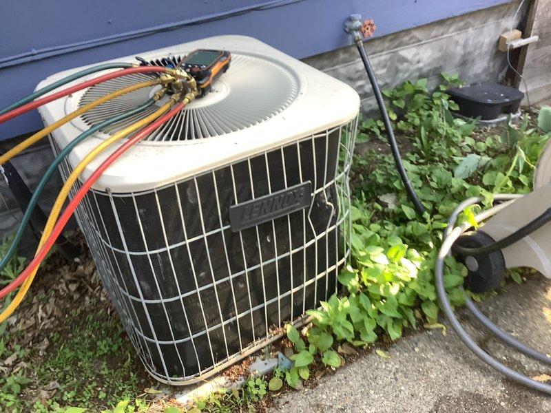 Completed annual cooling maintenance on outdoor condensing unit. Performed system diagnostics with electrical testing equipment to verify proper operation of compressor and fan motor. Inspected refrigerant lines, electrical connections, and overall unit condition, noting vegetation growth around base that may require clearing for optimal airflow and access for future service.