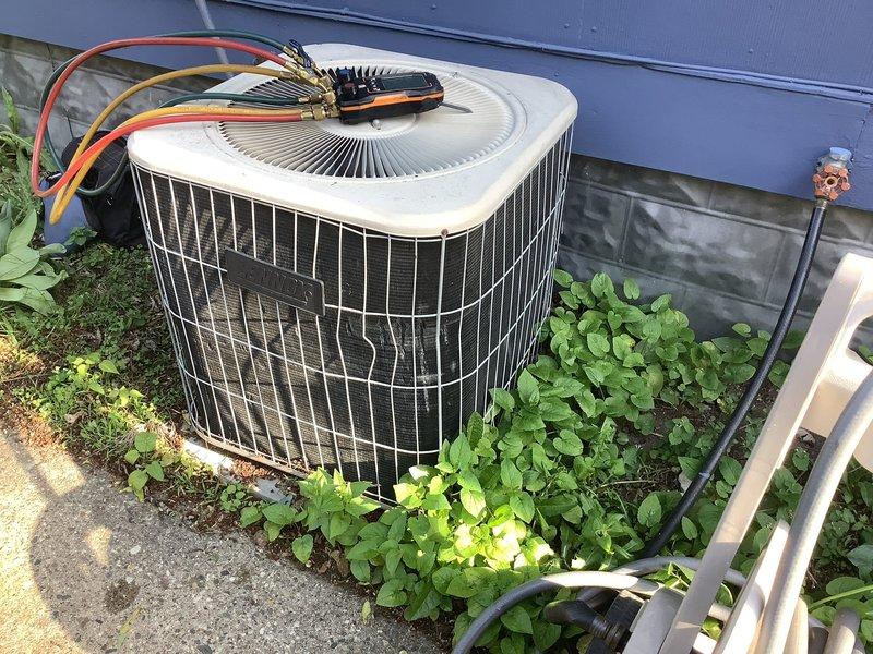 Completed annual cooling maintenance on outdoor condensing unit. Performed system diagnostics with electrical testing equipment to verify proper operation of compressor and fan motor. Inspected refrigerant lines, electrical connections, and overall unit condition, noting vegetation growth around base that may require clearing for optimal airflow and access for future service.