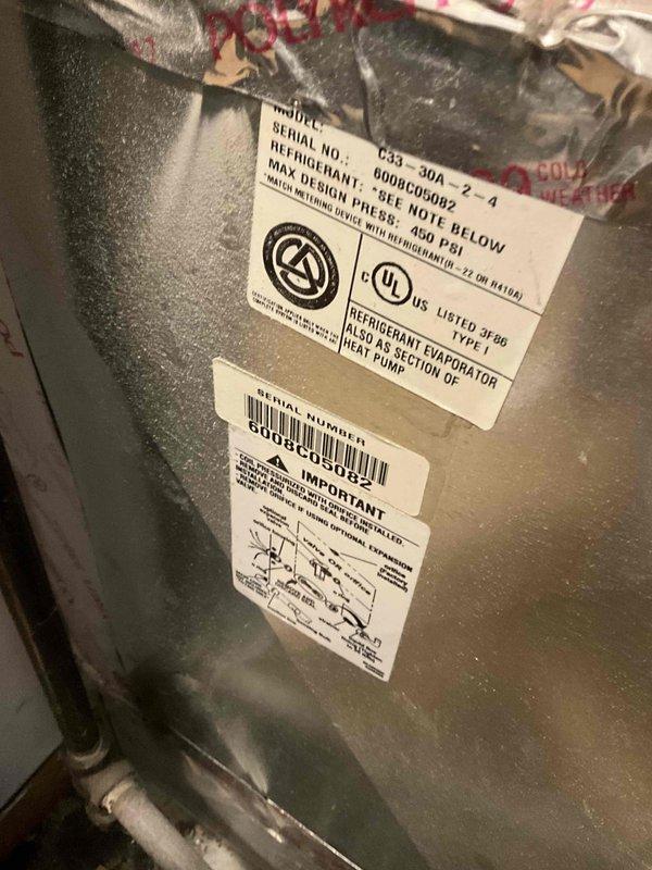 Performed comprehensive assessment of non-functional 12-year-old air conditioning system requiring full replacement. Documented existing equipment specifications including refrigerant evaporator coil and heat pump components, photographed manufacturer labels with technical ratings and serial numbers, and inspected electrical panel configuration to determine replacement requirements and ensure proper system compatibility for quote preparation.