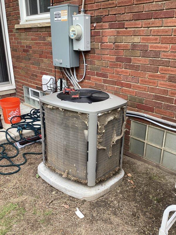 Completed annual cooling maintenance on residential air conditioning condenser unit. Performed comprehensive system inspection, measured refrigerant pressures and temperatures using digital manifold gauges, verified proper superheat and subcooling values, and documented unit condition. Unit shows significant exterior deterioration with corroded protective grilles and damaged screening, though system is currently operational with acceptable refrigerant charge levels.