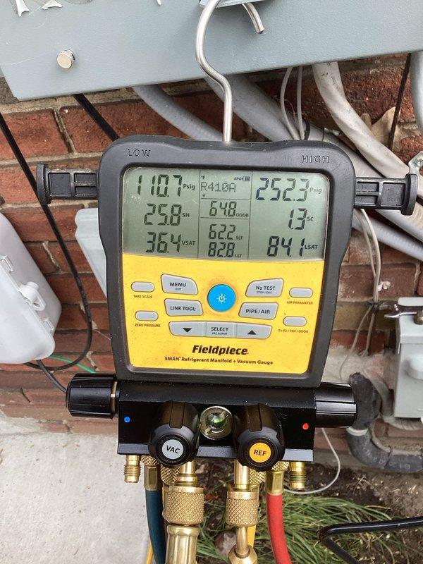 Completed annual cooling maintenance on residential air conditioning condenser unit. Performed comprehensive system inspection, measured refrigerant pressures and temperatures using digital manifold gauges, verified proper superheat and subcooling values, and documented unit condition. Unit shows significant exterior deterioration with corroded protective grilles and damaged screening, though system is currently operational with acceptable refrigerant charge levels.