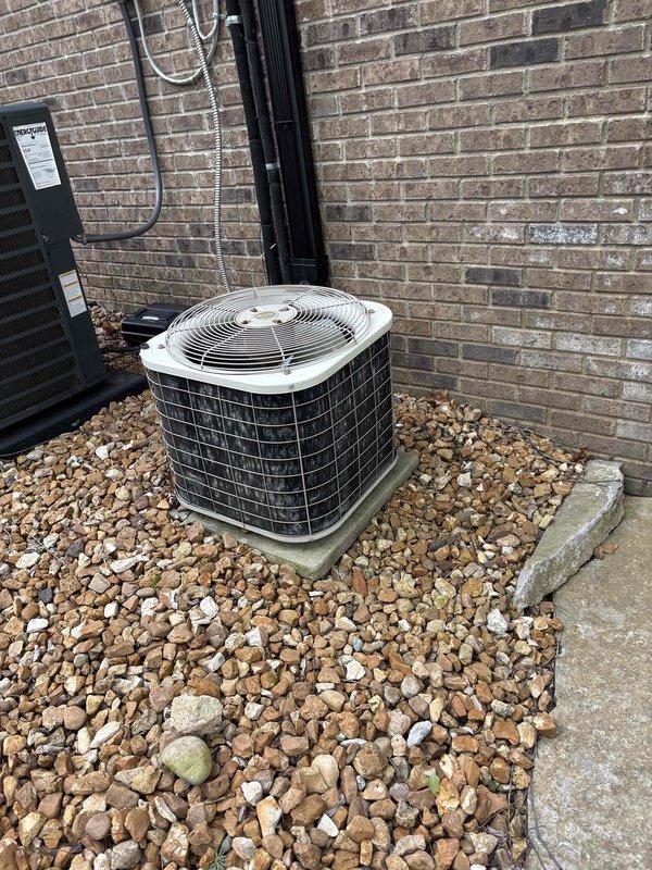 Conducted comprehensive assessment of 24-year-old non-operational natural gas furnace and air conditioning system located in lower level basement mechanical room. Evaluated existing gray metal furnace unit with exposed internal components, associated ductwork configuration, and outdoor condenser unit positioned on concrete pad with river rock landscaping against brick exterior wall. Provided detailed replacement estimate for complete HVAC system including furnace and air conditioning equipment to restore climate control functionality to residence.
