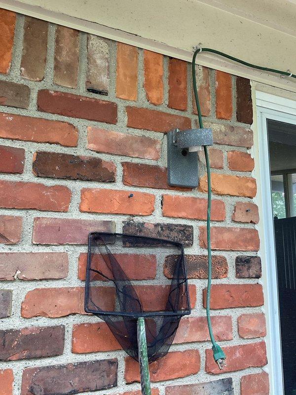 Replaced defective exterior light fixture with new black coach-style lantern on brick wall, installing proper conduit and ensuring secure mounting. Troubleshot and resolved non-functioning GFCI outlet issue. Removed two unwanted outdoor outlets from backyard area, capped wiring per code, and restored wall surfaces.