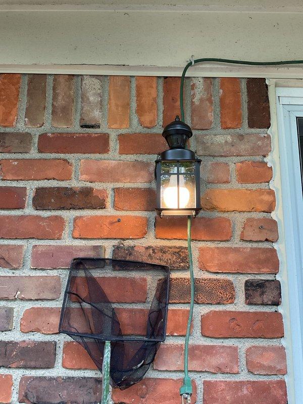 Replaced defective exterior light fixture with new black coach-style lantern on brick wall, installing proper conduit and ensuring secure mounting. Troubleshot and resolved non-functioning GFCI outlet issue. Removed two unwanted outdoor outlets from backyard area, capped wiring per code, and restored wall surfaces.