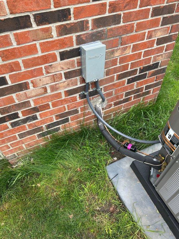 Installed two 30-amp fuses with fuse extenders in outdoor disconnect panel and secured disconnect box to brick exterior wall using anchor kit. This work was not completed during the original system installation and was necessary to ensure proper electrical protection and safe operation of the HVAC equipment.