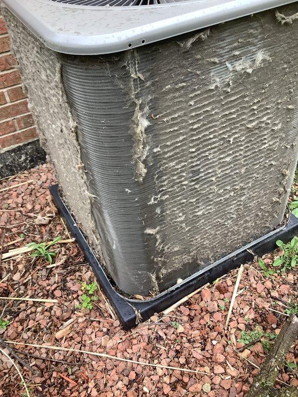 Completed comprehensive ComfortGuard maintenance package on both furnace and air conditioning systems. Furnace system, approximately 4 years old, received full tune-up including filter replacement and inspection of all operational components. Outdoor condenser unit required extensive cleaning due to heavy accumulation of debris, dirt, cottonwood fluff, and organic material lodged between condenser fins, which was restricting airflow and reducing system efficiency. Thoroughly cleaned condenser coils and exterior surfaces, removed all vegetation and debris from around unit base, and replaced condenser pad. Performed full system diagnostics on both heating and cooling equipment, verified proper refrigerant levels, checked electrical connections, tested thermostat operation, and confirmed all safety controls functioning correctly. Both systems tested and verified operational upon completion of maintenance service.