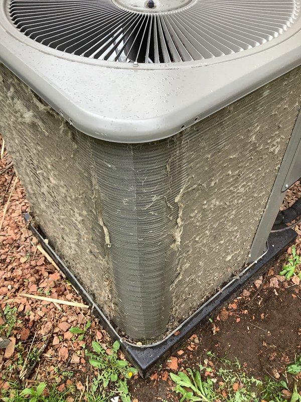 Completed comprehensive ComfortGuard maintenance package on both furnace and air conditioning systems. Furnace system, approximately 4 years old, received full tune-up including filter replacement and inspection of all operational components. Outdoor condenser unit required extensive cleaning due to heavy accumulation of debris, dirt, cottonwood fluff, and organic material lodged between condenser fins, which was restricting airflow and reducing system efficiency. Thoroughly cleaned condenser coils and exterior surfaces, removed all vegetation and debris from around unit base, and replaced condenser pad. Performed full system diagnostics on both heating and cooling equipment, verified proper refrigerant levels, checked electrical connections, tested thermostat operation, and confirmed all safety controls functioning correctly. Both systems tested and verified operational upon completion of maintenance service.