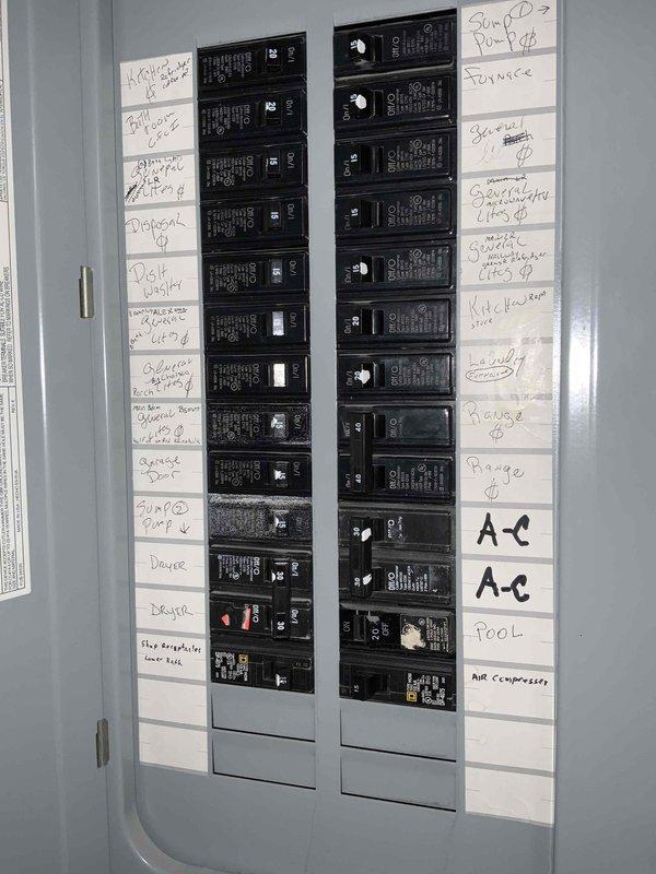 Completed electrical estimate for new whole home generator installation at manufactured home residence. Assessed existing electrical panel configuration in basement utility area, documented current circuit breaker layout serving kitchen, bathrooms, bedrooms, garage, pool equipment, and HVAC systems. Evaluated electrical infrastructure including panel capacity, wiring routes through ceiling joists, and available space for generator transfer switch integration to determine installation requirements and feasibility for backup power system.