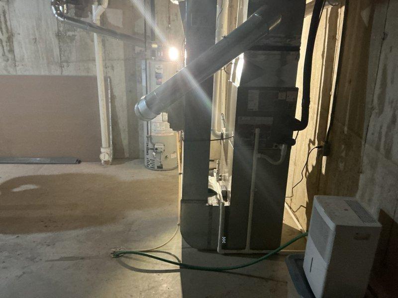 Completed installation of 2-ton air conditioning system with matching evaporator coil in basement mechanical room. Installed new air handler unit with copper refrigerant line set, connected ductwork with metallic elbow transitions, and established proper electrical connections. System was reconnected to existing infrastructure, tested for proper operation, and left fully functional per manufacturer specifications.