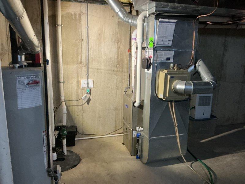 Completed installation of 2-ton air conditioning system with matching evaporator coil in basement mechanical room. Installed new air handler unit with copper refrigerant line set, connected ductwork with metallic elbow transitions, and established proper electrical connections. System was reconnected to existing infrastructure, tested for proper operation, and left fully functional per manufacturer specifications.