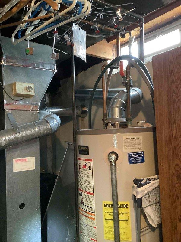 Completed comprehensive HVAC estimate for full system replacement in residential property. Evaluated existing air handler unit with evaporator coil assembly, ductwork connections, and blower housing configuration, along with current furnace installation and water heater setup in basement utility area. Documented equipment conditions, system layout, and spatial requirements through detailed photographic assessment to provide accurate replacement specifications and installation planning for new HVAC system.