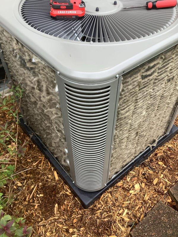 Completed routine Air Care Cooling maintenance on outdoor condensing unit. Unit was operating on deteriorated pad with significant exterior dirt and debris accumulation on cabinet panels and coil surfaces. Replaced black plastic equipment pad to ensure proper level support and drainage, then performed thorough cleaning of condenser coil and exterior surfaces to restore optimal airflow and heat transfer efficiency.