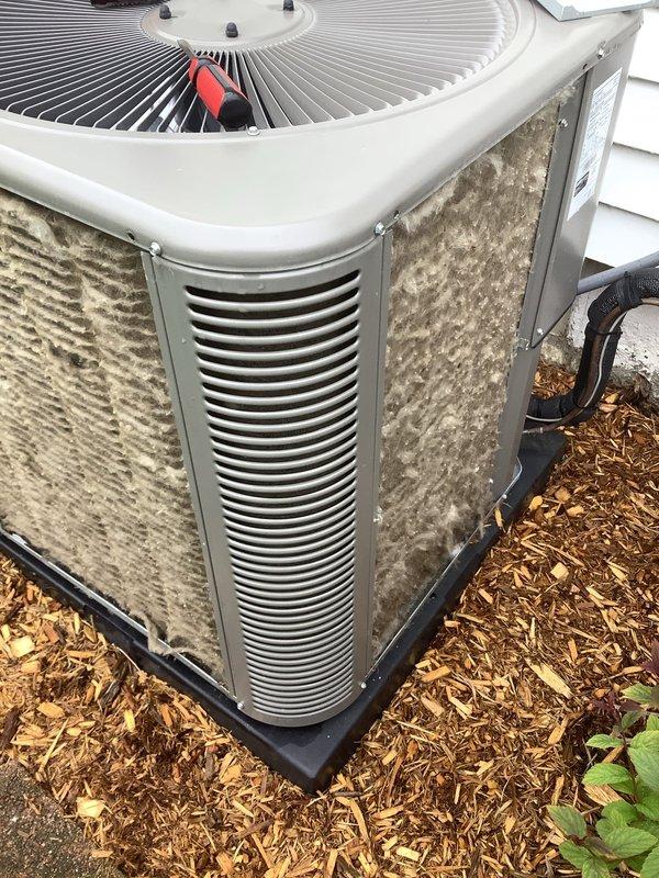 Completed routine Air Care Cooling maintenance on outdoor condensing unit. Unit was operating on deteriorated pad with significant exterior dirt and debris accumulation on cabinet panels and coil surfaces. Replaced black plastic equipment pad to ensure proper level support and drainage, then performed thorough cleaning of condenser coil and exterior surfaces to restore optimal airflow and heat transfer efficiency.