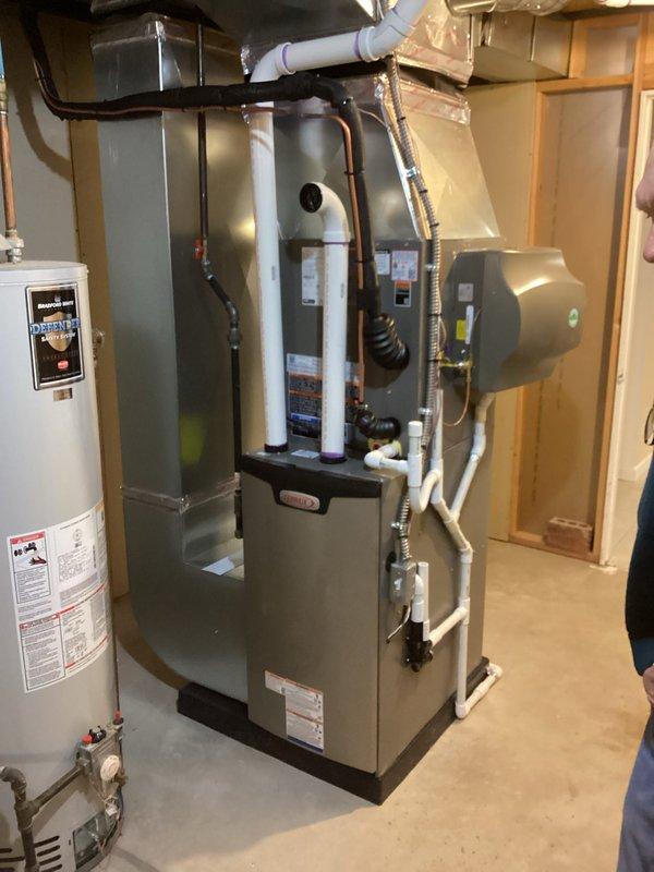 Completed full HVAC system installation including a Lennox 70,000 BTU furnace (model CK40CT-30B-71) and 2.5-ton air conditioning unit with rear discharge configuration. Installed humidifier and reconnected all necessary utilities and ductwork. All equipment installed in basement mechanical room per specifications, permits obtained prior to installation, and system tested for proper operation upon completion.