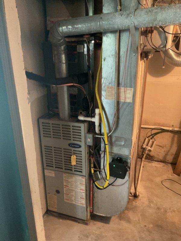 Successfully completed installation of new Lennox outdoor condensing unit and indoor evaporator coil system. Positioned exterior condenser on vibration-dampening pad against building foundation with proper clearances, connected refrigerant lines through wall penetration, and installed electrical disconnect boxes with appropriate conduit. Indoor evaporator coil was integrated with existing Carrier furnace in basement mechanical room, with refrigerant lines properly insulated and routed. Verified all electrical connections, tested refrigerant line integrity, and ensured proper drainage configuration. System startup completed with verification of proper operation and airflow.