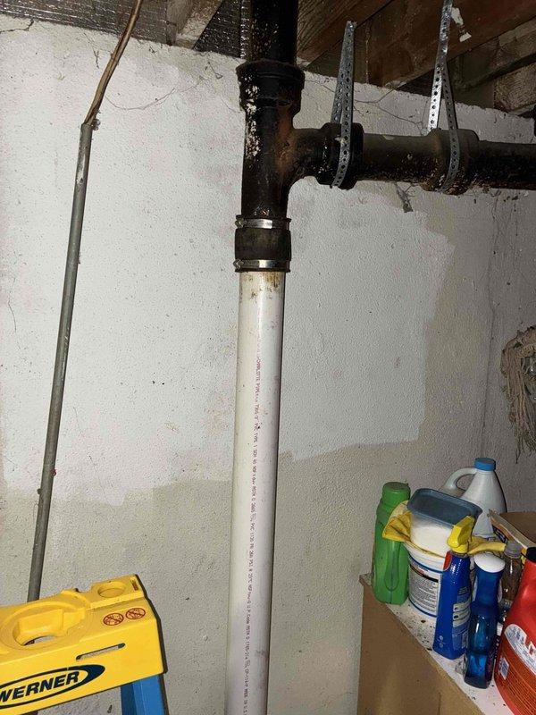 Responded to water leak investigation at residential property. Upon inspection, identified severely corroded cast iron drain piping at ceiling level in basement utility area, connected to white PVC vertical stack via coupling joint. Extensive rust and deterioration observed on horizontal cast iron section, indicating advanced age and compromising pipe integrity. Removed deteriorated piping sections, which exhibited heavy corrosion throughout with significant material degradation. Provided comprehensive assessment and quote for necessary repairs to address leak source and prevent future water damage.