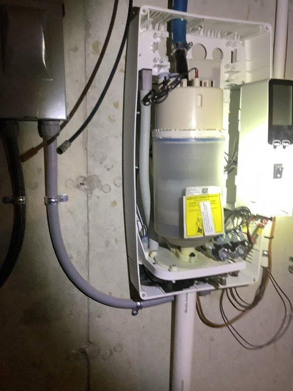 Responded to callback for continued water leakage from humidifier following previous plug replacement. Upon inspection, identified improper drain line installation and inadequate sealing at the PVC penetration point. Reinstalled humidifier drain line with proper pitch and secured connection, applied appropriate foam insulation around pipe penetration to prevent air infiltration, and verified all electrical connections at the equipment panel were secure and properly grounded. Tested system operation and confirmed no further water leakage from humidifier or drain assembly.