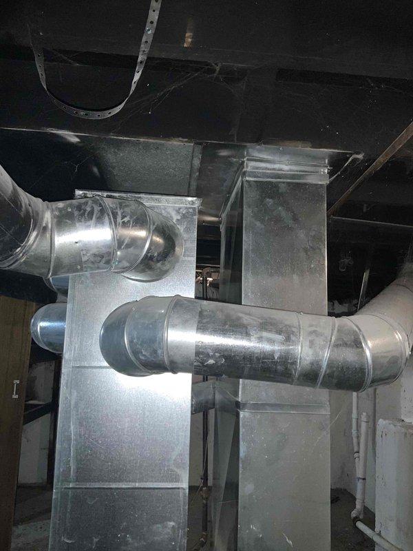 Completed comprehensive HVAC system evaluation for full air conditioning replacement estimate and chimney liner installation assessment. Inspected existing basement-mounted furnace and air handler configuration, documented current ductwork layout including galvanized metal supply ducts and connections, and photographed mechanical room conditions to provide accurate replacement specifications. Evaluated system accessibility, existing infrastructure compatibility, and provided detailed recommendations for complete AC unit replacement to address aging equipment with unknown service history.