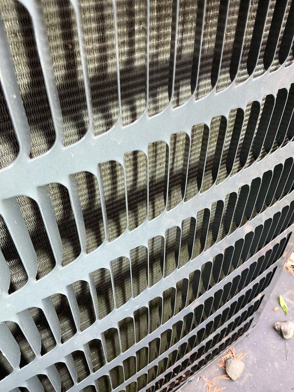Completed annual cooling maintenance on two rooftop units. Inspected condenser coils and found moderate accumulation of dust and debris between fins, which can restrict airflow and reduce system efficiency. Documented current condition of outdoor equipment and surrounding areas including deck and landscape features for maintenance records. All systems operational at time of service.