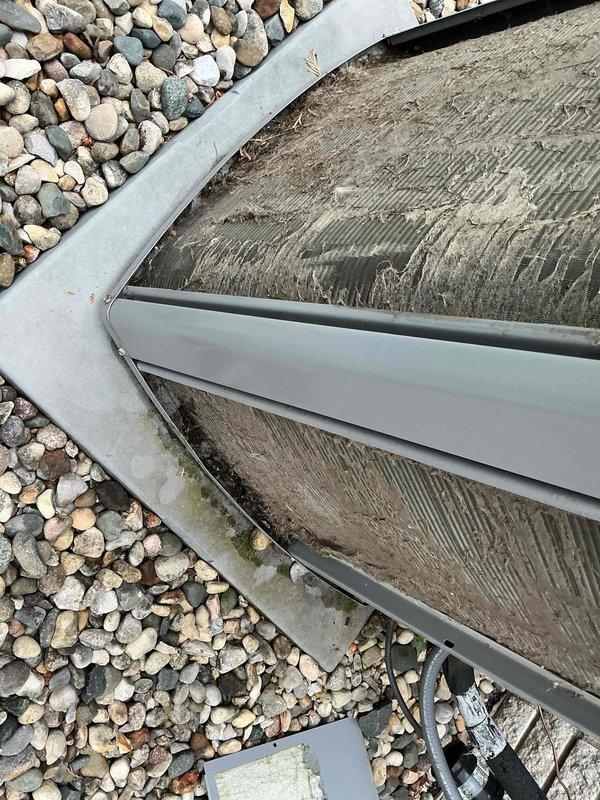Completed annual cooling maintenance on two rooftop units. Inspected condenser coils and found moderate accumulation of dust and debris between fins, which can restrict airflow and reduce system efficiency. Documented current condition of outdoor equipment and surrounding areas including deck and landscape features for maintenance records. All systems operational at time of service.