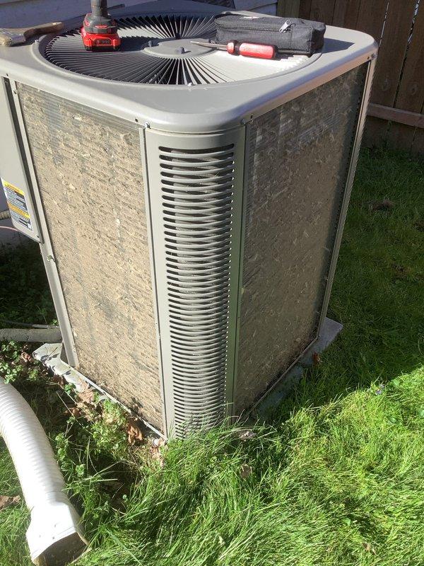 Performed comprehensive AC clean and check maintenance on outdoor condenser unit. Inspected system components, cleaned condenser coils and exterior cabinet surfaces which showed significant accumulation of dirt and environmental debris, verified fan operation and grille condition, and ensured proper airflow through louvered panels. Unit returned to normal operating condition with all maintenance tasks completed per standard protocol.