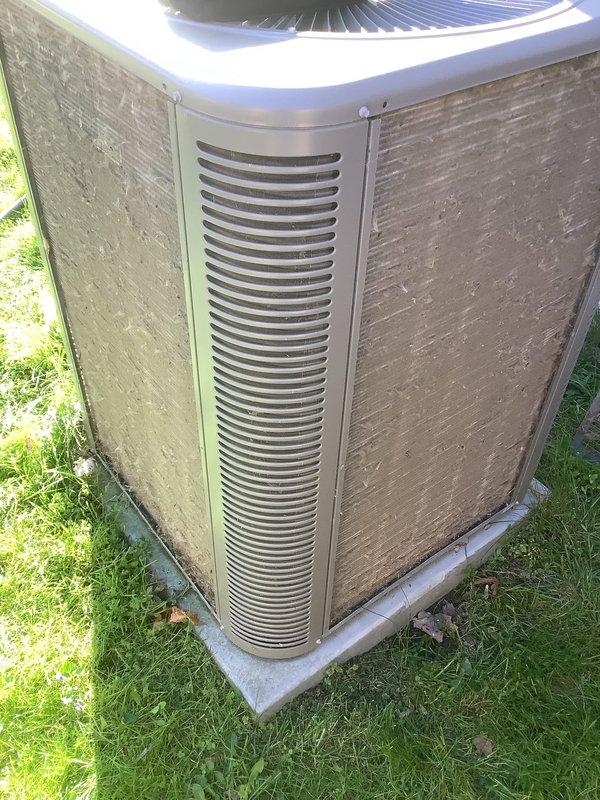Performed comprehensive AC clean and check maintenance on outdoor condenser unit. Inspected system components, cleaned condenser coils and exterior cabinet surfaces which showed significant accumulation of dirt and environmental debris, verified fan operation and grille condition, and ensured proper airflow through louvered panels. Unit returned to normal operating condition with all maintenance tasks completed per standard protocol.