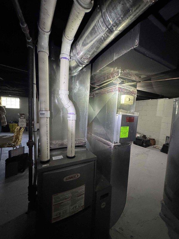 Provided comprehensive estimate for new air conditioning system installation in basement location. Property currently has existing Lennox furnace with no AC unit present. Evaluated existing HVAC infrastructure including ductwork system, air handler configuration, and available space for condenser placement. Assessed compatibility of proposed AC equipment with current furnace and existing sheet metal ductwork distribution system. Reviewed electrical requirements, condensate drainage routing options utilizing existing PVC piping infrastructure, and refrigerant line set routing from proposed outdoor unit location to indoor evaporator coil installation point. Documented mechanical room layout and existing HVAC components to determine optimal placement and integration of new cooling system with minimal modifications to current setup.