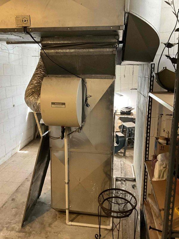 Conducted estimate for replacement of 2002 air conditioning system currently low on R-22 refrigerant, with possible furnace replacement consideration. Evaluated existing natural gas furnace and humidifier installation in basement utility area, along with outdoor A/C unit located in side yard. Assessed current HVAC system configuration including ductwork, plenum assembly, and humidifier integration to provide comprehensive equipment replacement recommendations.