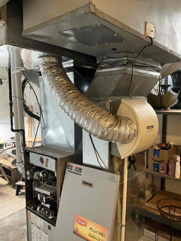 Conducted estimate for replacement of 2002 air conditioning system currently low on R-22 refrigerant, with possible furnace replacement consideration. Evaluated existing natural gas furnace and humidifier installation in basement utility area, along with outdoor A/C unit located in side yard. Assessed current HVAC system configuration including ductwork, plenum assembly, and humidifier integration to provide comprehensive equipment replacement recommendations.