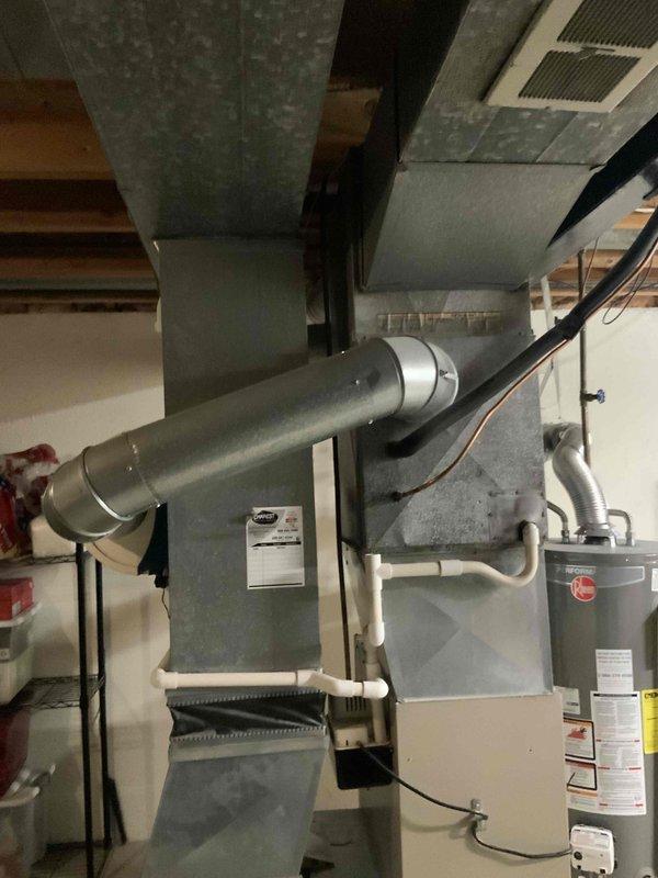 Completed full system estimate for residential HVAC replacement. Evaluated 15-year-old air conditioning unit with confirmed refrigerant leak at outdoor condenser and 15-year-old furnace with intermittent operational failures. Assessed humidifier experiencing water leakage issues. Documented existing equipment configuration including outdoor condenser unit on concrete pad, basement-installed furnace with metallic venting, and integrated humidification system. Photographed current system conditions and installation layout. Provided comprehensive replacement options for complete HVAC system due to age of equipment and multiple component failures requiring immediate attention within customer's one-month timeline.