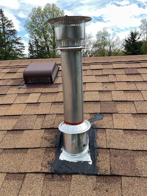 Completed full HVAC system installation including a 70,000 BTU furnace, 2-ton air conditioning unit positioned on right side with reconnection, and water heater tank. Obtained mechanical and electrical permits prior to installation. Installed new chimney vent pipe through roof with proper flashing, weatherproof boot seal, and rain cap, along with secondary roof ventilation stack with galvanized piping and white metal rain cap. All roof penetrations sealed with appropriate flashing materials and rubber gaskets to ensure weathertight integrity. System startup and testing completed successfully with all equipment operating to manufacturer specifications.