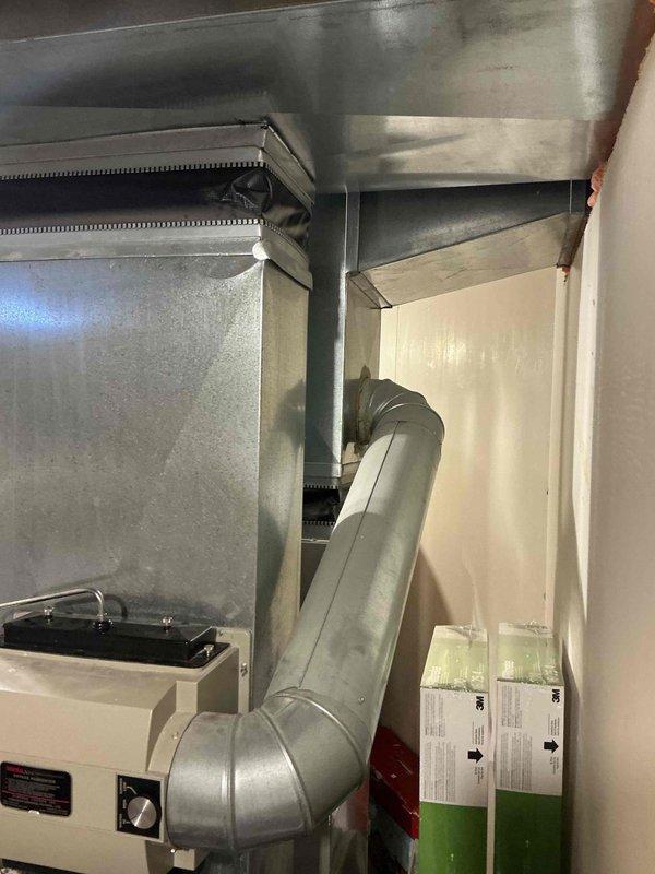 Provided comprehensive estimate for air conditioning system replacement in basement location. Current 27-year-old unit remains operational but has exceeded typical service lifespan. Documented existing HVAC installation including ductwork configuration, equipment positioning within confined mechanical space, and associated plumbing systems. Assessed accessibility considerations for replacement work given equipment location in utility area with existing water heater and circulation pump assembly.