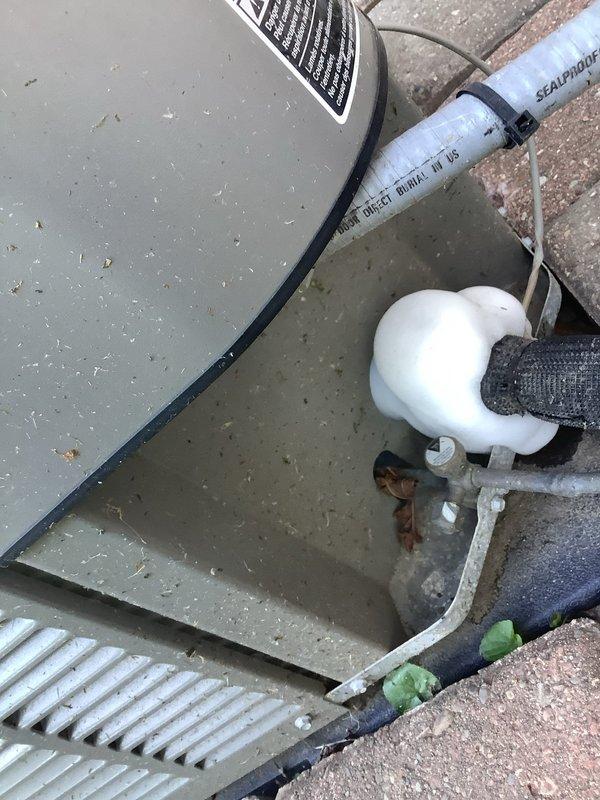 Responded to callback for outdoor AC unit not turning off following previous service visit where wiring was replaced. Upon arrival, inspected condensate drain system and float switch assembly, which was found to be preventing proper unit shutdown. Cleaned debris from outdoor unit top surface, verified fan operation, and tested condensate drainage components to ensure proper cycling. System tested successfully with unit now shutting off as designed.
