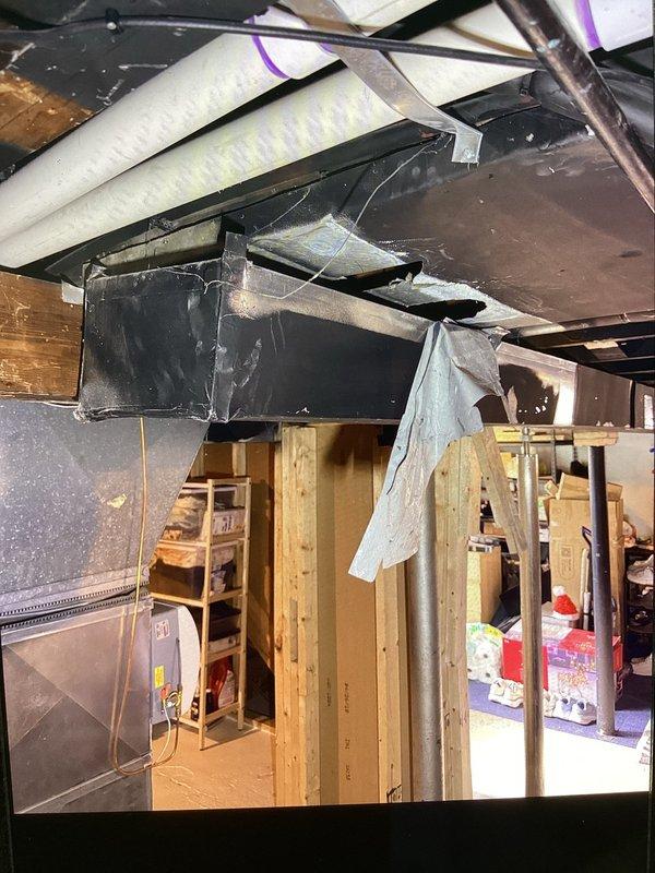 Responded to service call for reported holes in HVAC system affecting a 12-year-old furnace located in basement. Upon inspection, identified compromised return ductwork with visible openings that were allowing unconditioned air infiltration and reducing system efficiency. Documented existing conditions showing exposed ductwork, insulation gaps, and areas requiring sealing to restore proper system operation and prevent energy loss.