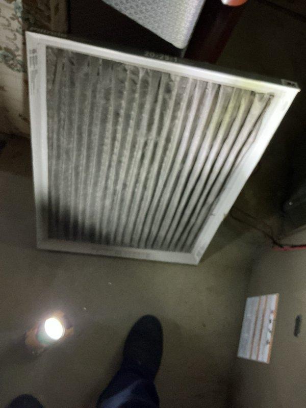 Completed routine Air Care Cooling maintenance inspection on residential HVAC system. Inspected air return filter grille which showed heavy dust and debris accumulation requiring attention, and performed diagnostic testing on system components using digital meter to verify proper operation. Documented equipment conditions with photos for service records.