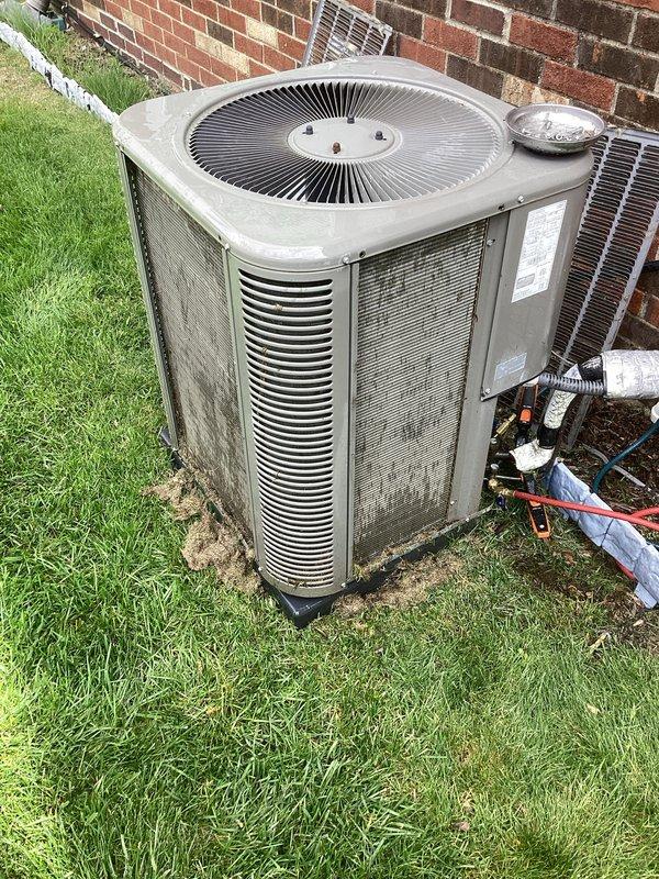 Performed scheduled air conditioning maintenance on outdoor condenser unit. Inspected refrigerant lines, verified service port caps were secure, checked electrical connections, and examined fan assembly and coil condition. Unit operational with no deficiencies noted at time of service.