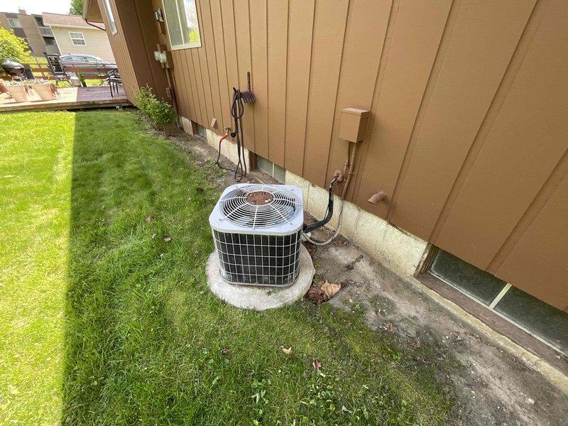 Completed on-site estimate for HVAC system replacement involving a 20+ year-old air conditioning unit and existing furnace. Assessed basement-installed green furnace with overhead ductwork and black air handler configuration, along with exterior white condensing unit mounted on concrete pad against building siding. Evaluated current system condition, measured equipment specifications, documented installation requirements including electrical service, ductwork connections, and placement constraints in utility room with water heater proximity. Provided comprehensive replacement options under promotional program, discussed equipment efficiency ratings, system sizing requirements, and installation scope for complete furnace and air conditioning changeout to address aging equipment concerns.