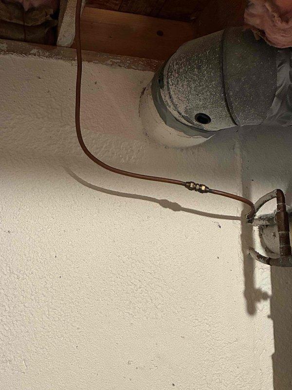 Completed comprehensive whole home plumbing inspection for new homeowner following up on previous inspector's findings. Addressed gas leak at water heater by inspecting connections and gas supply lines, identifying source of leak and performing necessary repairs to ensure safe operation. Installed dedicated shut-off valve on gas line near dryer location to provide proper isolation capability for the appliance. Replaced existing rigid copper gas piping to dryer with code-compliant corrugated stainless steel tubing (CSST), ensuring proper flexibility and safety standards for gas appliance connection. Verified all gas connections for leaks using approved testing methods, confirmed proper operation of water heater and gas supply system throughout home, and documented conditions with photographic evidence of work areas including attic space gas lines and basement water heater installation.