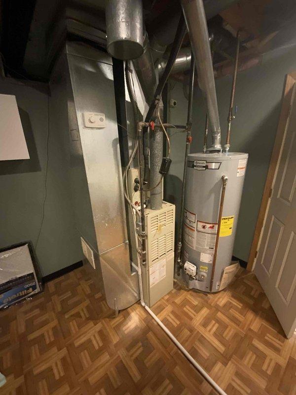 Completed on-site assessment for furnace replacement estimate on 32-year-old unit currently located in basement mechanical room. Existing furnace remains operational but has exceeded typical service life expectancy. Documented current installation configuration including ductwork connections, venting system, electrical supply, and gas line routing to provide accurate replacement specifications and ensure proper equipment sizing for the residence.