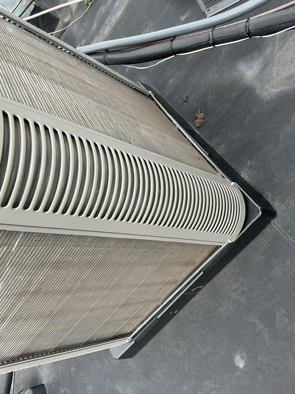 # HVAC Maintenance - ACM Completed

Performed scheduled preventive maintenance on rooftop air conditioning unit as part of recurring Air Care Cooling service agreement. Inspected and documented condition of air filtration system, including two large corrugated air filters housed in metal frames. Filters showed moderate dust accumulation consistent with normal operation. Examined ventilation components including white louvered vent covers with vertical slats and associated ductwork. Verified proper installation and security of insulated refrigerant lines and flexible duct connections with cable ties. Assessed overall system condition, noting typical operational wear on filter media and rooftop mounting surfaces. All HVAC components inspected and photographed for service records. System operational and ready for continued service.