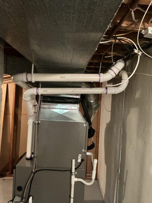 Completed full HVAC system installation including a 70,000 BTU furnace, 2-ton air conditioning unit, and humidifier in basement mechanical room. Installed all necessary ductwork, PVC condensate drain lines, copper refrigerant lines, and electrical connections. Secured equipment on protective platform, routed all piping and conduit per code requirements, and reconnected existing utilities. Mechanical permit obtained prior to installation. System tested and operational upon completion.