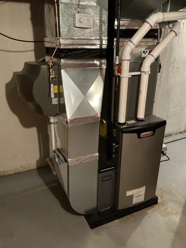 Completed full HVAC system installation including a 70,000 BTU furnace, 2-ton air conditioning unit, and humidifier in basement mechanical room. Installed all necessary ductwork, PVC condensate drain lines, copper refrigerant lines, and electrical connections. Secured equipment on protective platform, routed all piping and conduit per code requirements, and reconnected existing utilities. Mechanical permit obtained prior to installation. System tested and operational upon completion.