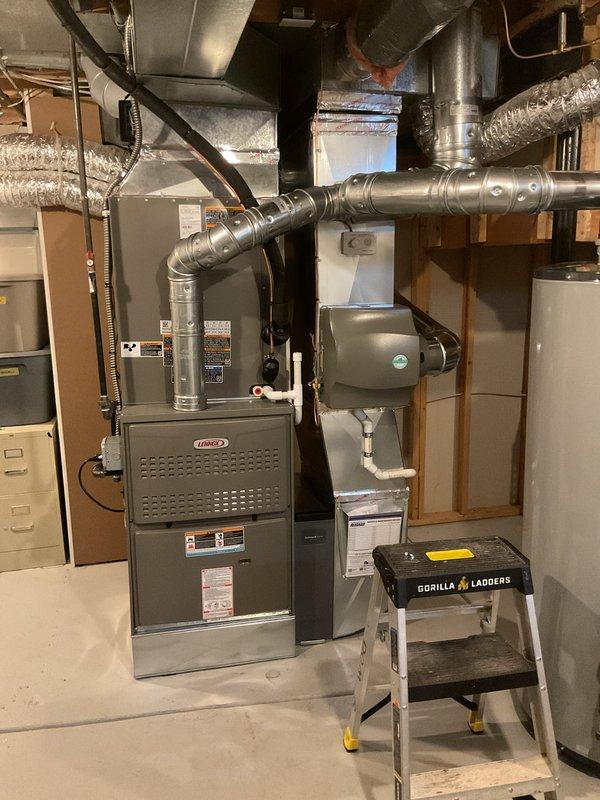 Completed full HVAC system installation including a Lennox 135,000 BTU gas furnace with rear discharge configuration and 4-ton air conditioning unit. Installed whole-home humidifier with integrated plumbing connections and mounted Emerson programmable thermostat for system control. Reconnected all ductwork, exhaust venting, electrical connections, and condensate lines to existing infrastructure. All mechanical, electrical, and furnace permits obtained and work performed to code specifications.