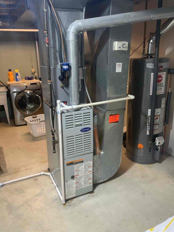Provided comprehensive replacement estimate for 20+ year old basement-installed HVAC system including natural gas furnace, air conditioning unit, and humidifier. Assessed existing Carrier furnace installation, ductwork configuration, electrical panel capacity, and current system layout to determine optimal replacement specifications and installation requirements for complete comfort system upgrade.
