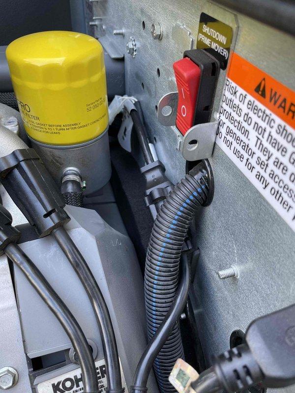 Performed follow-up service visit to generator unit to install cold weather kit. Inspected engine compartment and verified proper access to coolant system components, including engine block heater connections and associated hoses. Documented current configuration of Kohler generator system, including oil cooler assembly, shutdown controls, and electrical safety systems prior to scheduled cold weather kit installation. Unit requires return visit to complete cold weather kit installation at no charge.
